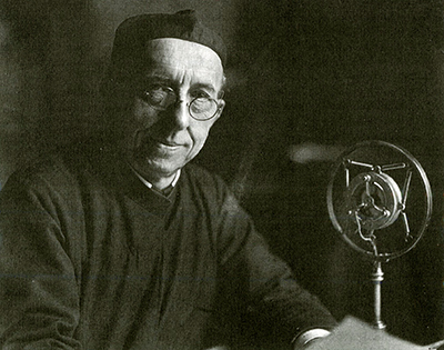 George Rueppel, S.J. at the Mic